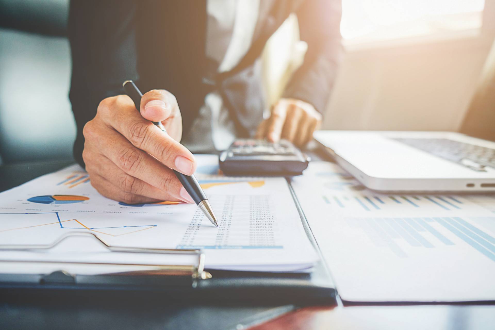 a business person writing on a piece of paper